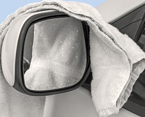 Terry cloth draped over car's sideview mirror
