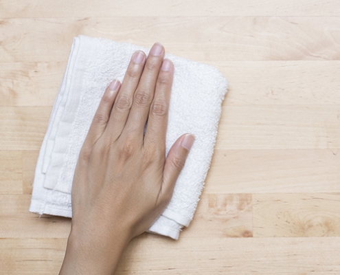 Hand with terry cloth, wiping surface