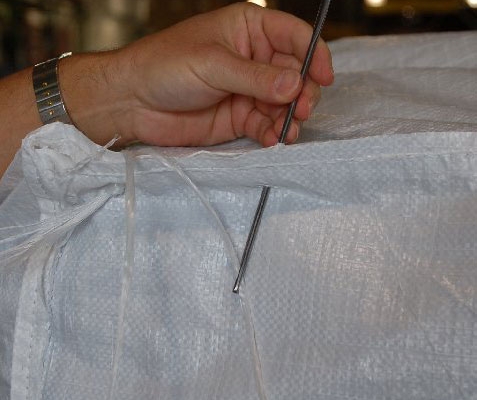 needle sewing a capsack closed